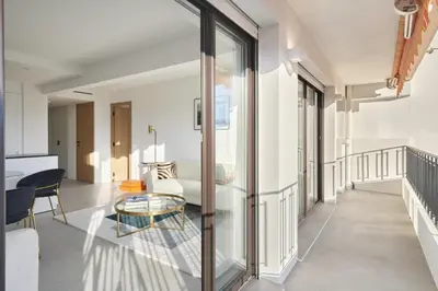 a living room with glass doors and a table at Wdf 2 bedroom heart of Cannes in Cannes