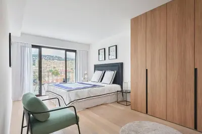 a bedroom with a bed and a large window at Wdf 2 bedroom heart of Cannes in Cannes