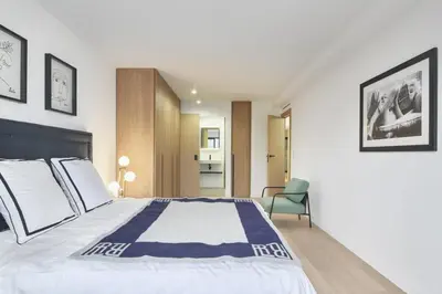 a bedroom with a large bed and a chair at Wdf 2 bedroom heart of Cannes in Cannes