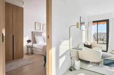 a bedroom with a bed and a chair in a room at Wdf 2 bedroom heart of Cannes in Cannes