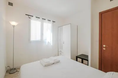 a white bedroom with two towels on a bed at Wonderful 2 bedrooms in the heart of Cannes ! in Cannes