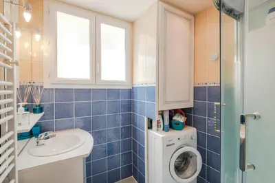a bathroom with a washing machine and a sink at Wonderful 2 bedrooms in the heart of Cannes ! in Cannes