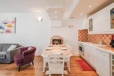 a kitchen and living room with a table and a couch at Wonderful 2 bedrooms in the heart of Cannes ! in Cannes