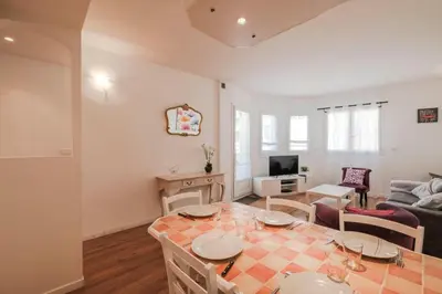 a kitchen and living room with a table and a couch at Wonderful 2 bedrooms in the heart of Cannes ! in Cannes