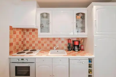 a kitchen with white cabinets and a sink at Wonderful 2 bedrooms in the heart of Cannes ! in Cannes