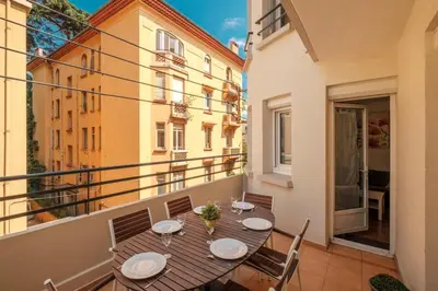 a balcony with a table and chairs on a balcony at Wonderful 2 bedrooms in the heart of Cannes ! in Cannes