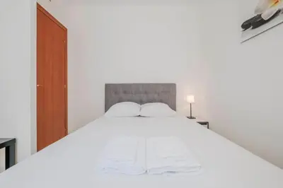 a bedroom with a white bed with two pillows at Wonderful 2 bedrooms in the heart of Cannes ! in Cannes