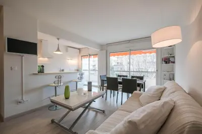 a living room with a couch and a table at Wonderful 1 bedroom 3 min walk to the Croisette! in Cannes