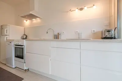 a kitchen with white cabinets and a white refrigerator at Wonderful 1 bedroom 3 min walk to the Croisette! in Cannes