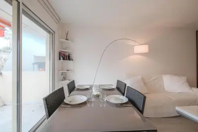 a dining room with a table and a couch at Wonderful 1 bedroom 3 min walk to the Croisette! in Cannes