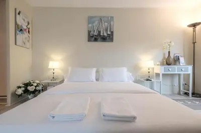 a bedroom with a large white bed with towels on it at Cozystay 1087 - Charming studio historic Suquet in Cannes