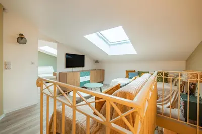 a room with two bunk beds and a skylight at Beautiful two bedroom duplex apartment in Cannes