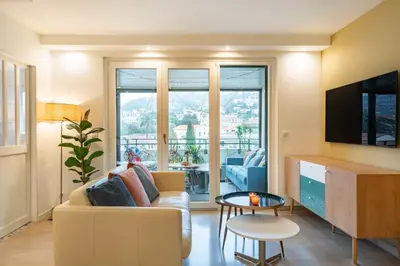 a living room with a couch and a tv at Beautiful two bedroom duplex apartment in Cannes