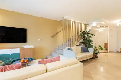 a living room with a couch and a tv at Beautiful two bedroom duplex apartment in Cannes