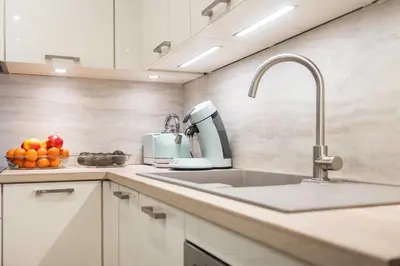 a kitchen with a sink and a mixer at Beautiful two bedroom duplex apartment in Cannes