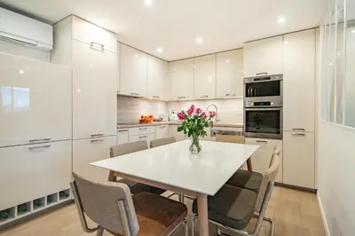a kitchen with a white table and chairs at Beautiful two bedroom duplex apartment in Cannes