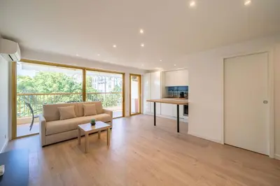 a living room with a couch and a table at Beautiful studio with balcony in Cannes in Cannes