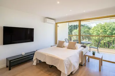 a bedroom with a bed and a large window at Beautiful studio with balcony in Cannes in Cannes