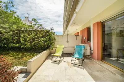 two chairs sitting on a patio next to a building at Pleasant 2 bedroom with large terrace in Cannes