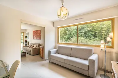 a living room with a couch and a window at Pleasant 2 bedroom with large terrace in Cannes