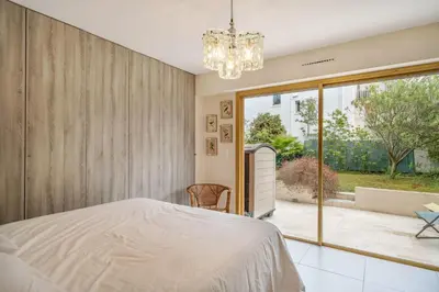 a bedroom with a bed and a large window at Pleasant 2 bedroom with large terrace in Cannes