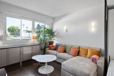 a living room with a couch and a table at Agréable studio à deux pas de la Croisette in Cannes