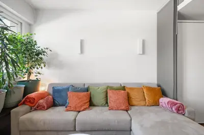 a couch with colorful pillows on it in a living room at Agréable studio à deux pas de la Croisette in Cannes