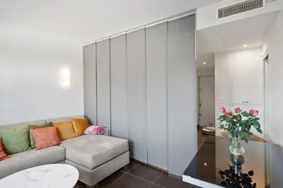 a living room with a couch and a table at Agréable studio à deux pas de la Croisette in Cannes