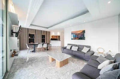 a living room with a couch and a table at Superbe appartement 5 pièces sur la Croisette in Cannes
