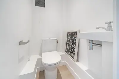 a white bathroom with a toilet and a sink at Superbe appartement 5 pièces sur la Croisette in Cannes