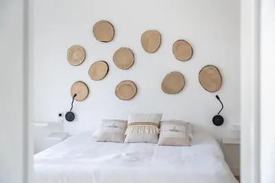 a bedroom with a white bed with wooden hats on the wall at Superbe appartement 5 pièces sur la Croisette in Cannes