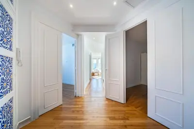 an open hallway with white doors and wood floors at Superb two-bedroom near the Croisette in Cannes