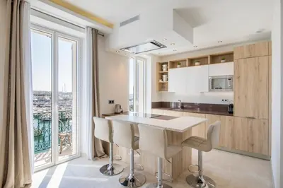 a kitchen with a table and a large window at Cozystay 1243 Port & Sea View Cannes in Cannes