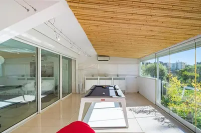 an open living room with a ping pong table at Brand new 3 bedrooms heart of Cannes in Cannes