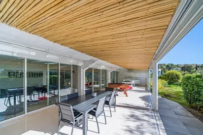 a dining room and living room with a wooden ceiling at Brand new 3 bedrooms heart of Cannes in Cannes