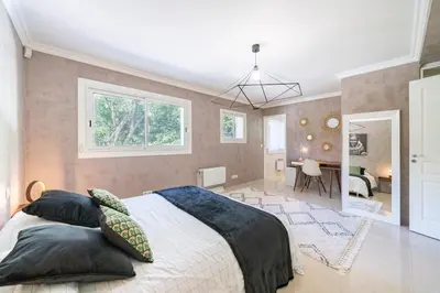 a bedroom with a bed and a dining room at Brand new 3 bedrooms heart of Cannes in Cannes
