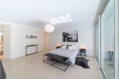a white bedroom with a bed and a large window at Brand new 3 bedrooms heart of Cannes in Cannes
