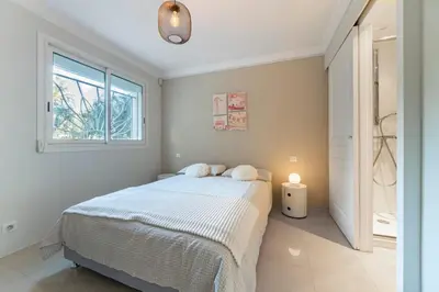 a bedroom with a bed and a window at Brand new 3 bedrooms heart of Cannes in Cannes
