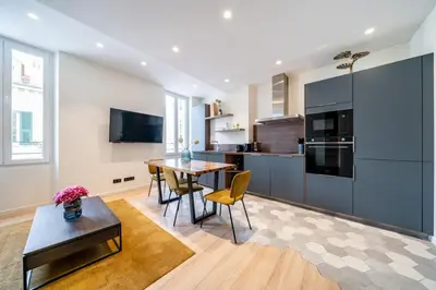 a kitchen and dining room with a table and chairs at Pleasant 2 bedroom in the heart of Cannes in Cannes