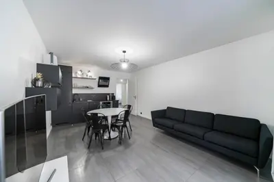 a living room with a couch and a table at COZYSTAY - Brand new 3 bedrooms 2min walk to carlton hotel in Cannes