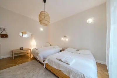 two beds in a room with white walls at Cozystay 1225 Bourgeois Charm in Cannes Center in Cannes
