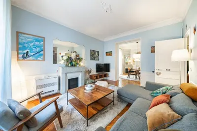 a living room with a couch and a table at Cozystay 1225 Bourgeois Charm in Cannes Center in Cannes