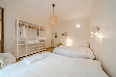 two beds in a room with white at Cozystay 1225 Bourgeois Charm in Cannes Center in Cannes