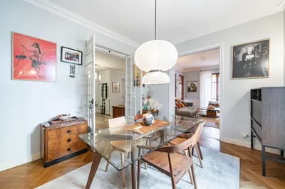 a dining room with a glass table and chairs at Cozystay 1225 Bourgeois Charm in Cannes Center in Cannes