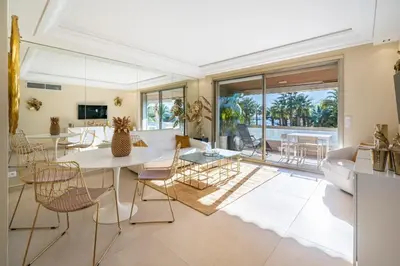 a living room with a white table and chairs at Wonderful 2 bedroom facing the Croisette in Cannes