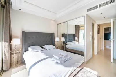 a bedroom with a large bed with towels on it at Wonderful 2 bedroom facing the Croisette in Cannes