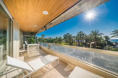 a balcony with views of the ocean and palm trees at Wonderful 2 bedroom facing the Croisette in Cannes