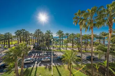 a view of a parking lot with palm trees at Wonderful 2 bedroom facing the Croisette in Cannes