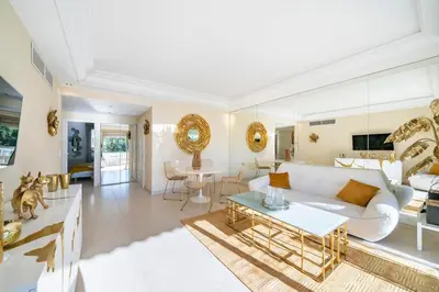 a living room with a white couch and a table at Wonderful 2 bedroom facing the Croisette in Cannes