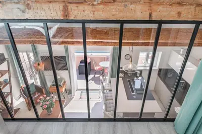 an aerial view of a living room with glass windows at Cozystay 1674 - Gorgeous sea view 3-bedroom duplex in Cannes
